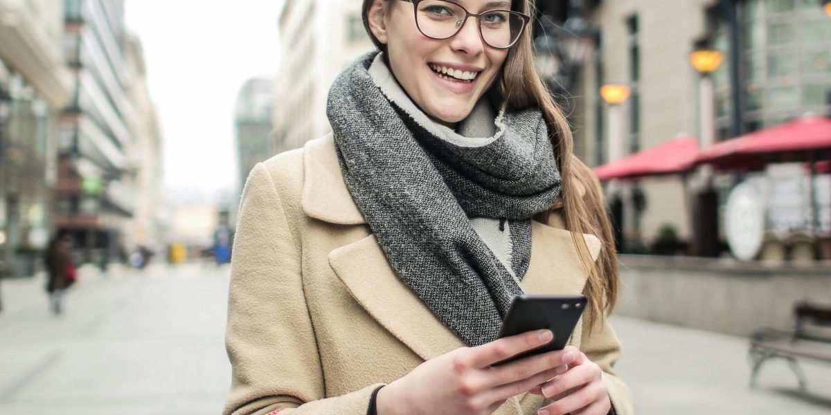 Osoba dokonująca zakupów online na smartfonie, odzwierciedlająca dominację mobile commerce.